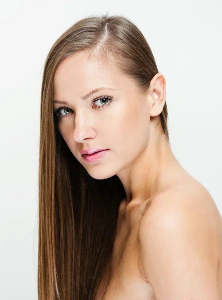 Closeup portrait of a beautiful young woman with long hair — Stock Photo, Image