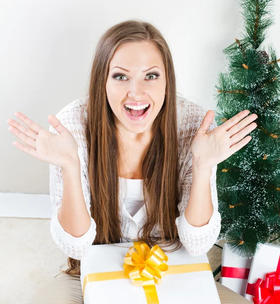 Woman with christmas gifts suprising — Stock Photo, Image