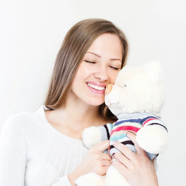 Brunette embraces teddy bear