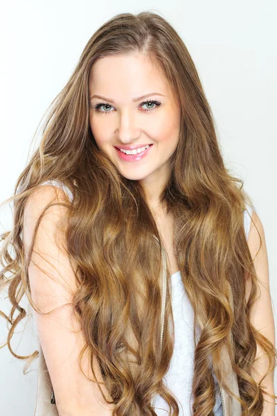 Beautiful young woman with long curly hairs — Stock Photo, Image