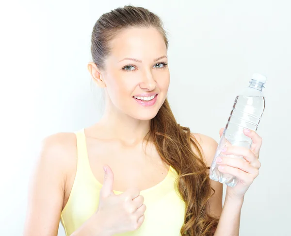 Beautiful woman with bottle of water over white — Stock Photo, Image
