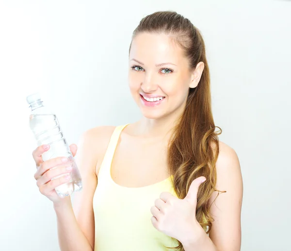 Beautiful woman with bottle of water over white — Stock Photo, Image