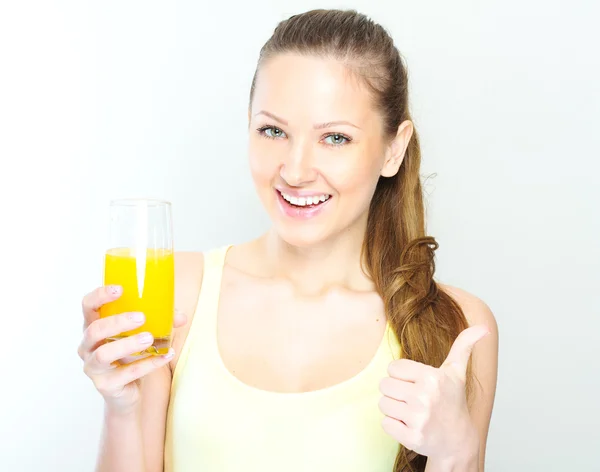Beautiful happy smiling female with yellow orange juice. — Stock Photo, Image