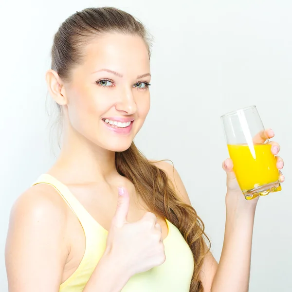 Beautiful happy smiling female with yellow orange juice. — Stock Photo, Image