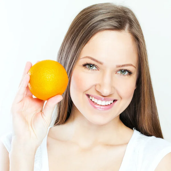 Portrait of a young beautiful woman with orange — Stock Photo, Image