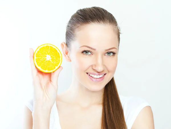 Portrait of a young beautiful woman with orange — Stock Photo, Image