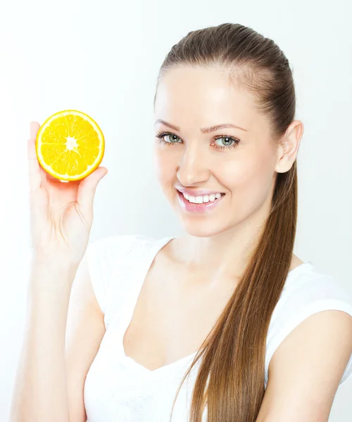 Portrait of a young beautiful woman with orange — Stock Photo, Image