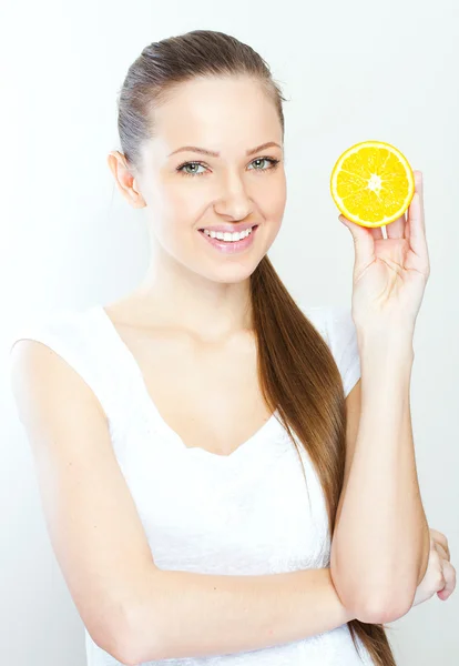 Portrait of a young beautiful woman with orange — Stock Photo, Image