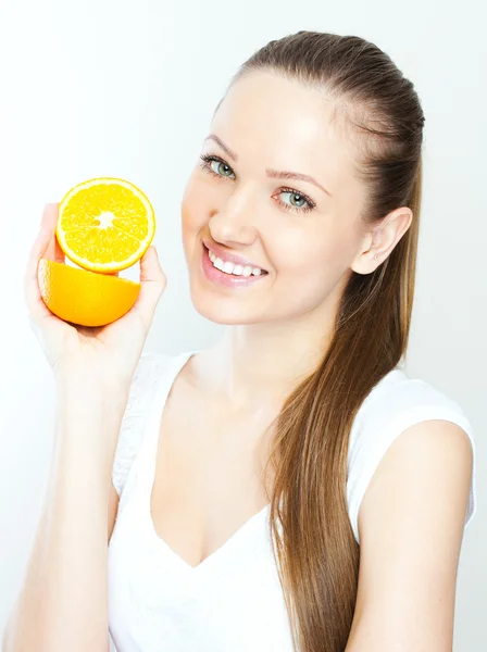 Portrait of a young beautiful woman with orange — Stock Photo, Image