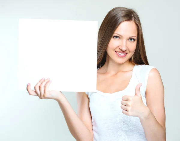 Happy woman holding blank poster — Stock Photo, Image