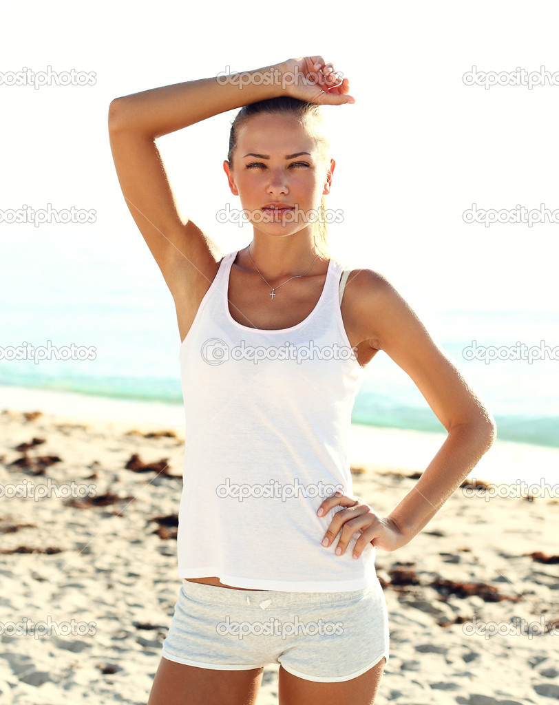 Athlete girl on the beach after workout