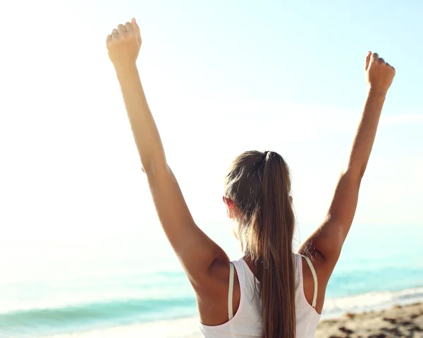 Successful sportswoman raising arms — Stock Photo, Image