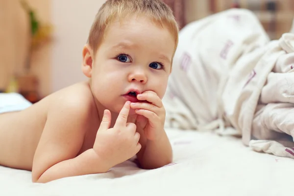 Curious little baby boy lying in bed at home — Stock Photo, Image