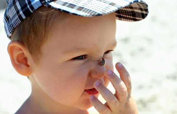 Bug captura de bebê engraçado bonito rapaz no nariz — Fotografia de Stock