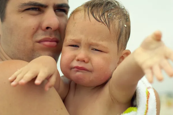 Piccolo bambino sconvolto che piange, che si allunga le mani. con padre all'aperto — Foto Stock