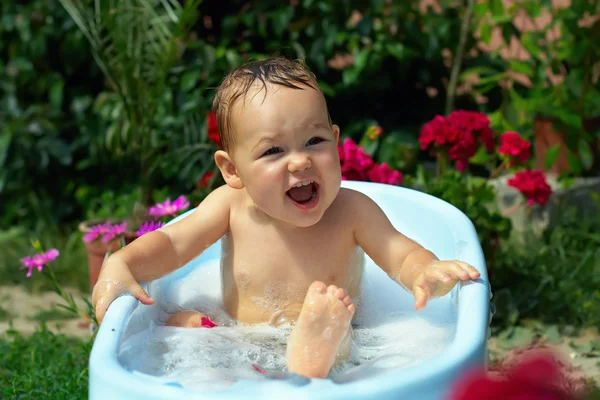 Cute funny little boy bathing outdoor in green garden — Stock Photo, Image