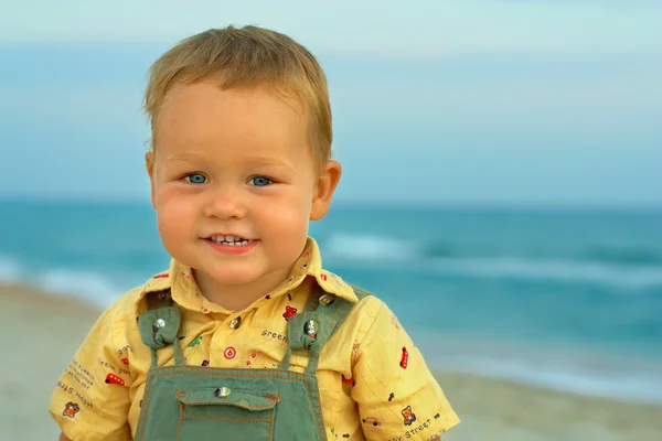 Close-up portrait of adorable smiling baby boy standing near the — Stock Photo, Image