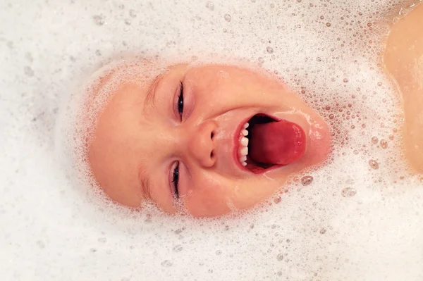 Happy baby face in bubble bath — Stok Foto