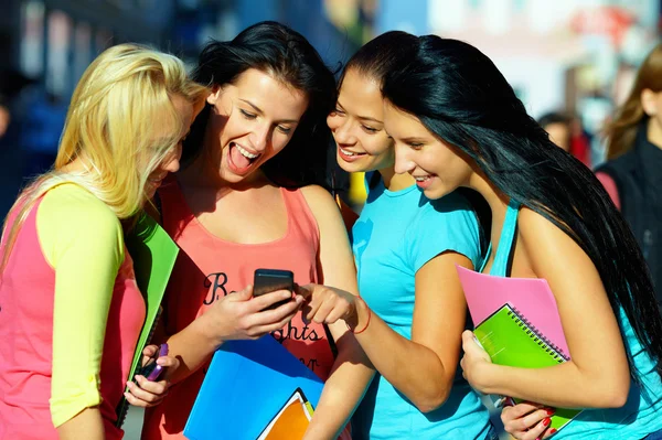 Grupper av kvinnelige studenter som chatter i sosialt nettverk på mobil – stockfoto