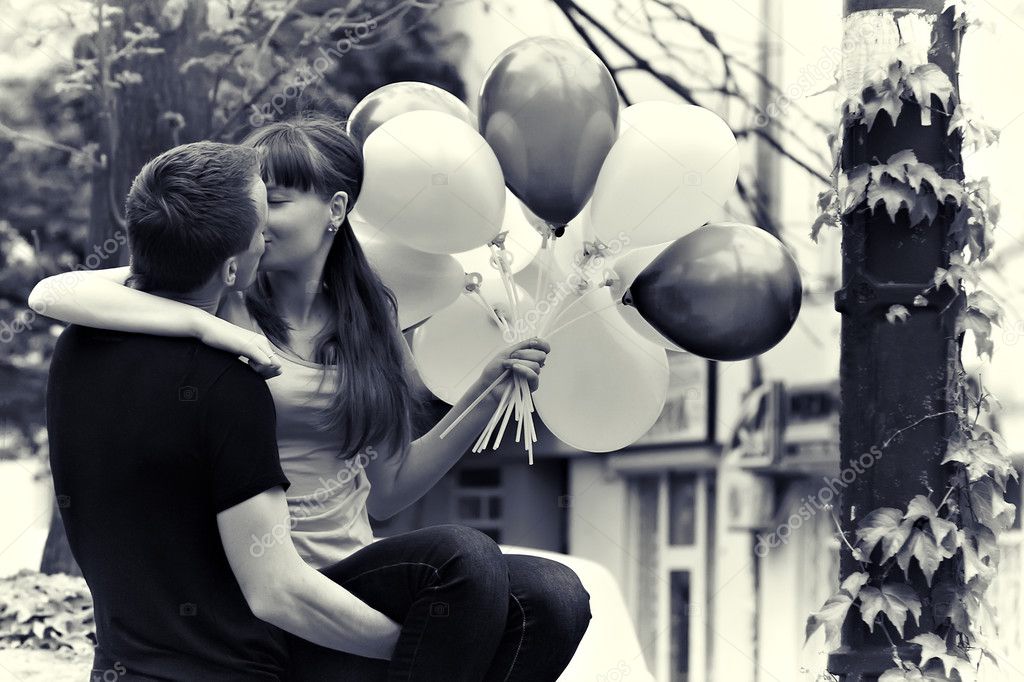 Love couple kiss, with balloons outdoor