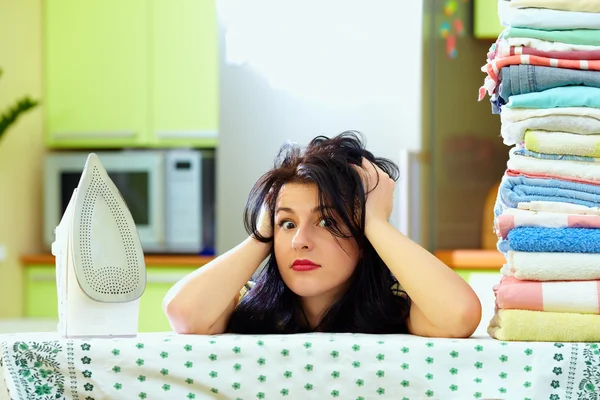 Tired housewife after ironing clothes, home interior — Stock Photo, Image