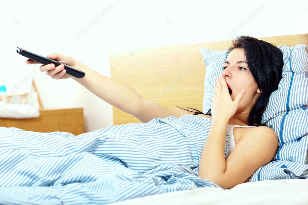 Woman watching tv in the morning