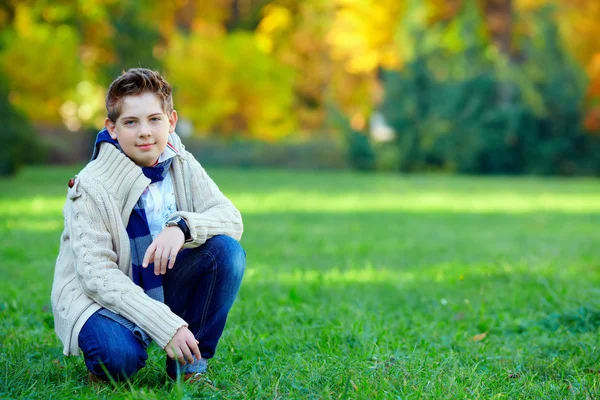 Eleganta tonårspojke i grön park — Stockfoto