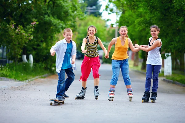 Happy teenage friends playing outdoors Stock Image