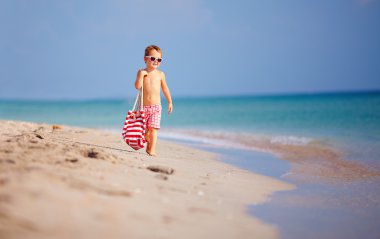 cute kid boy walking the sea beach clipart
