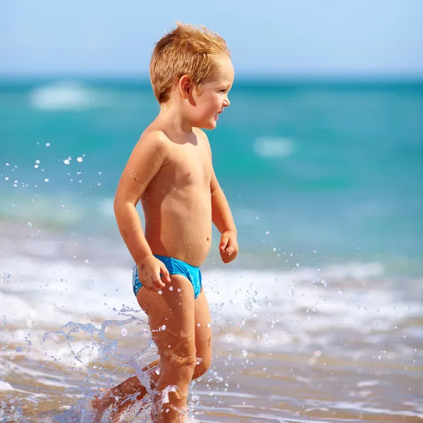 Cute kid boy having fun in sea surf — Stock Photo, Image