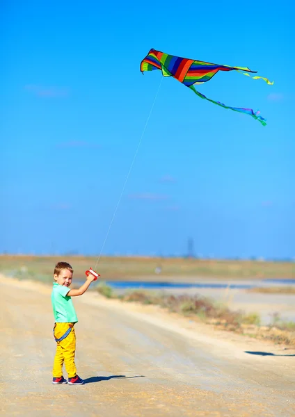 Happy kid playing with kite — Stock Photo, Image