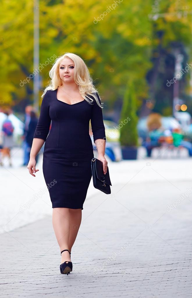 confident overweight woman walking the city street