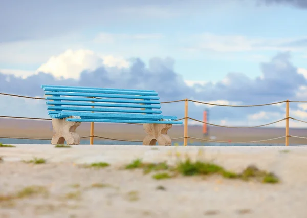 Old blue bench on cloudy background — Stock Photo, Image