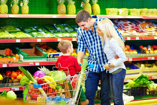 Retrato sincero da família comprando comida no supermercado — Fotografia de Stock