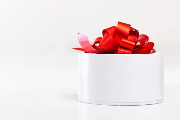 White gift box with red ribbon isolated — Stockfoto