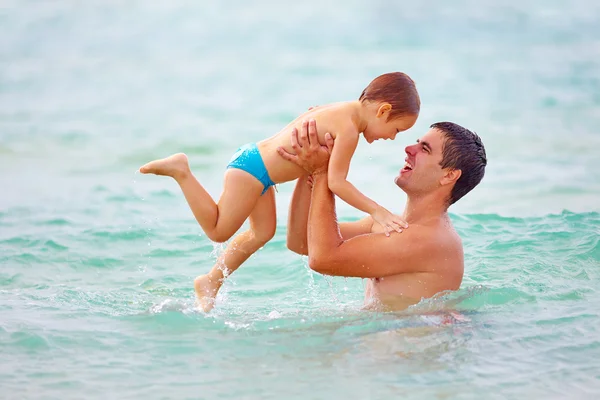 Playful father and son having fun in water — Stock Photo, Image