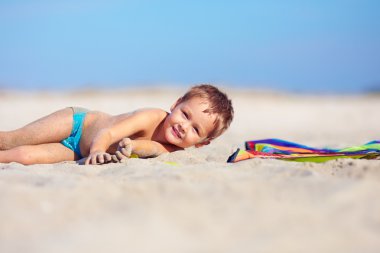 playful kid having fun on the beach