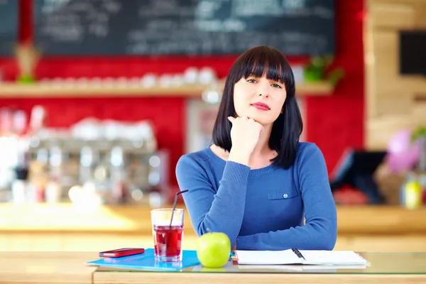Beautiful girl student in cafe — Stock Photo, Image