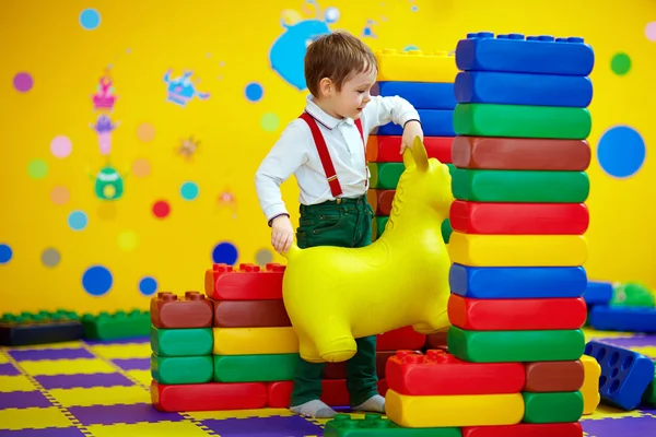 Happy kid playing with toys in kindergarten — Stock Photo, Image