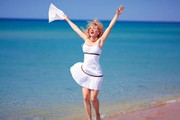 Happy girl jumping on summer beach — Stock Photo, Image