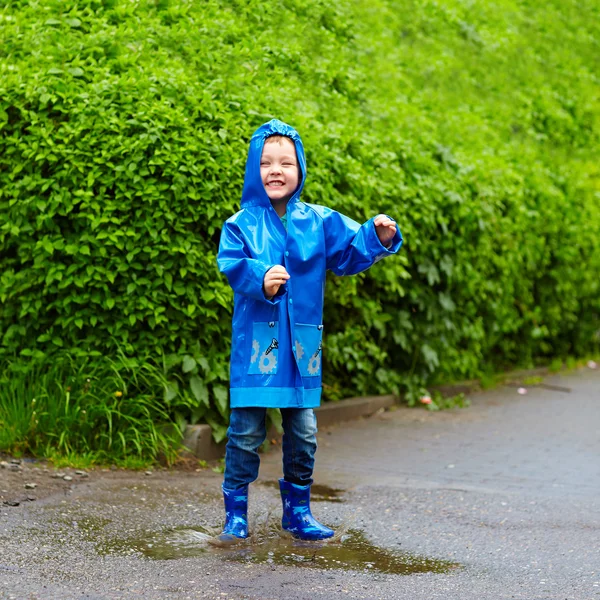 Divertente bambino felice saltando in pozzanghere — Foto Stock