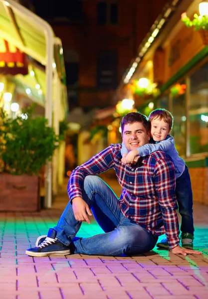 Portrait of young family on night city street — Stock Photo, Image