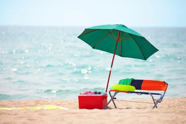 Folding furniture and ice box on summer beach — Stock Photo, Image