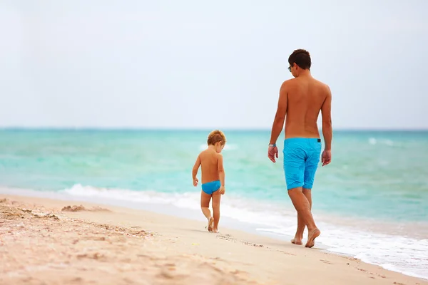 Padre e hijo caminando por la playa del mar —  Fotos de Stock