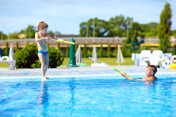 Niños felices divirtiéndose, jugando en el parque acuático —  Fotos de Stock