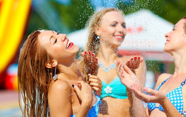 Laughing girls having fun under summer shower — Stock Photo, Image