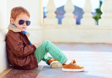 cute stylish boy in leather jacket and gum shoes clipart
