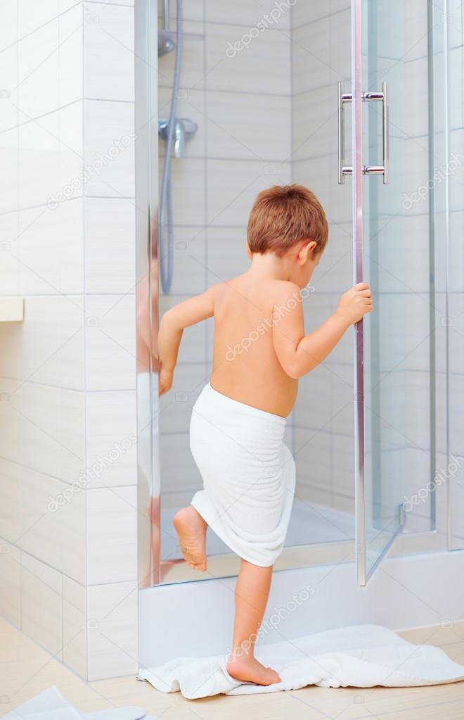 cute kid ready to wash himself in shower