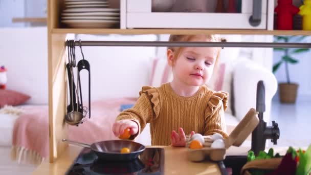 Cute Little Baby Girl Playing Toy Kitchen Pretending Fry Eggs — Stock Video