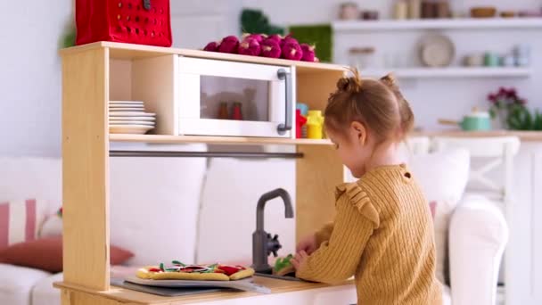 Cute Little Baby Girl Plays Toy Kitchen Pretending Make Lunch — Stock Video
